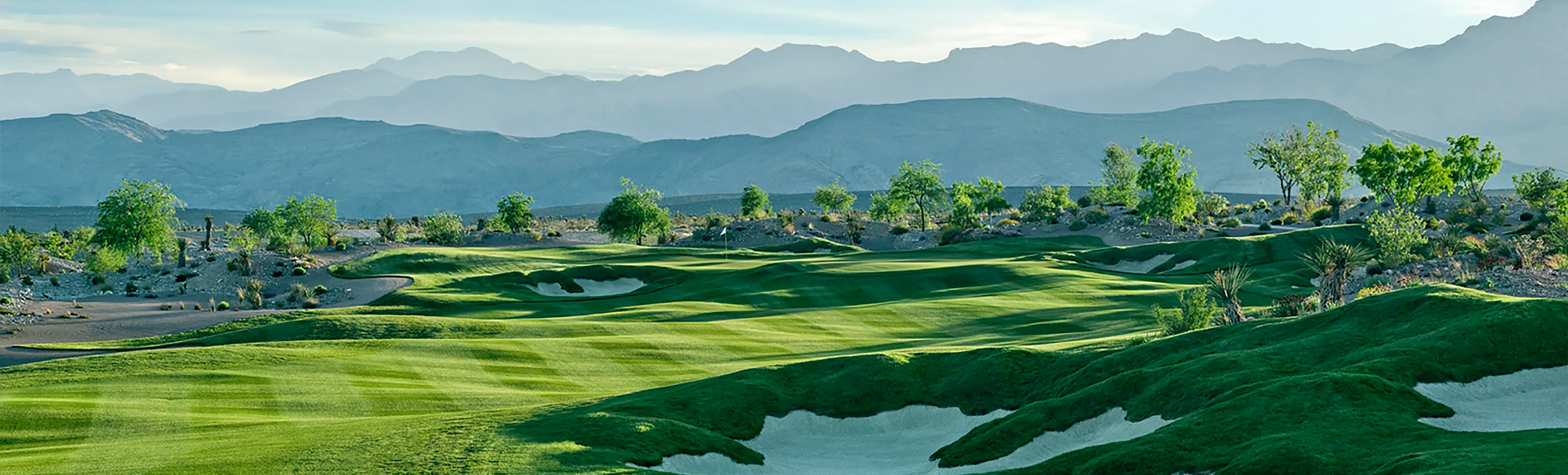 Coyote Springs Golf Club hole with bunkers desert landscape and mountain backdrop